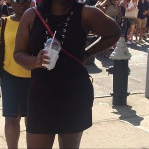 Sleeveless black dress with tie at chest